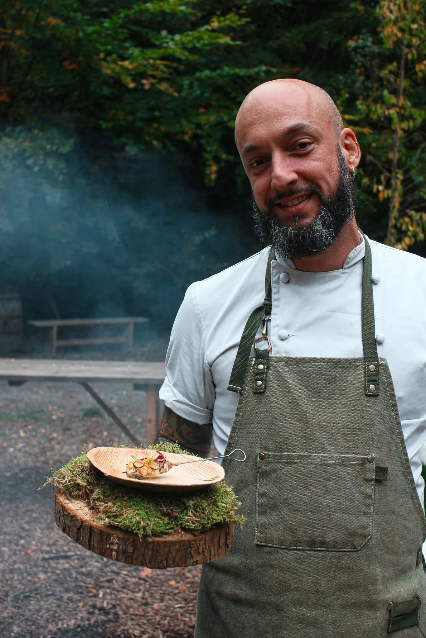 Mario holding a dish served on moss and wood